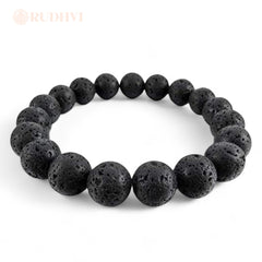 Black lava stone protection bracelet worn on wrist, energy and grounding purpose, white background