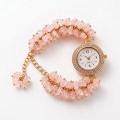  Feminine pink crystal bracelet watch with rose quartz stones and luxury styling.