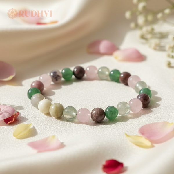 Multicolored beaded bracelet on a soft surface with petals and flowers