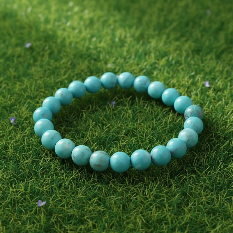 Turquoise (Firoza) Healing Bracelet by Rudhvi placed on green grass – natural gemstone bracelet for peace and positivity