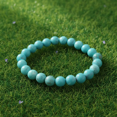 Turquoise (Firoza) Healing Bracelet by Rudhvi placed on green grass – natural gemstone bracelet for peace and positivity
